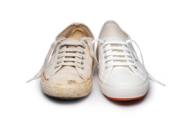 Close-up of an old and new canvas tennis shoe, isolated on white.